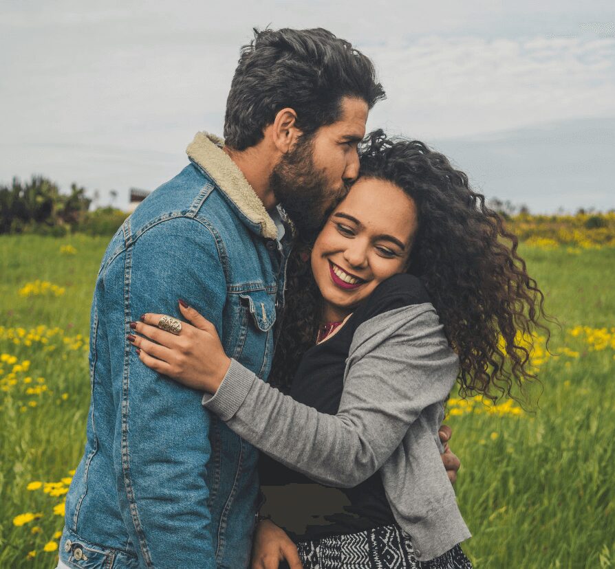 Couple embracing in a field