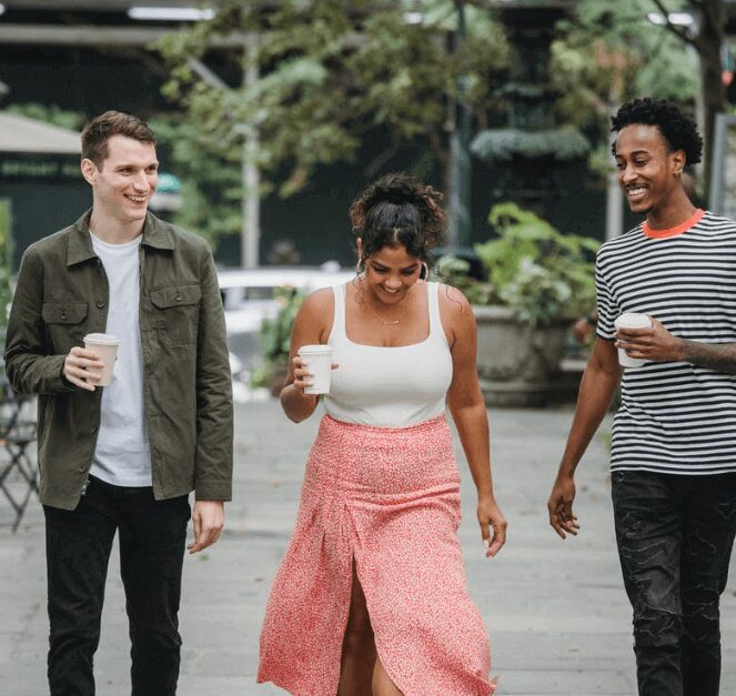 Three people strolling while chatting