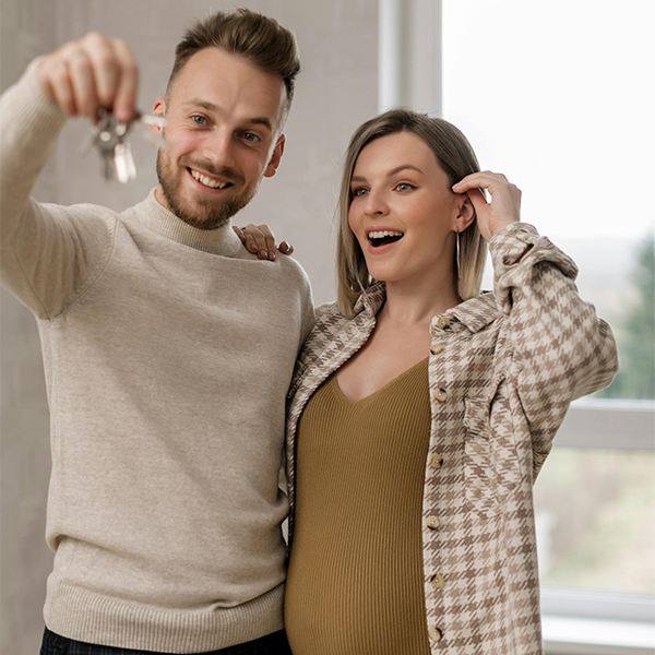 Smiling duo celebrating new home purchase