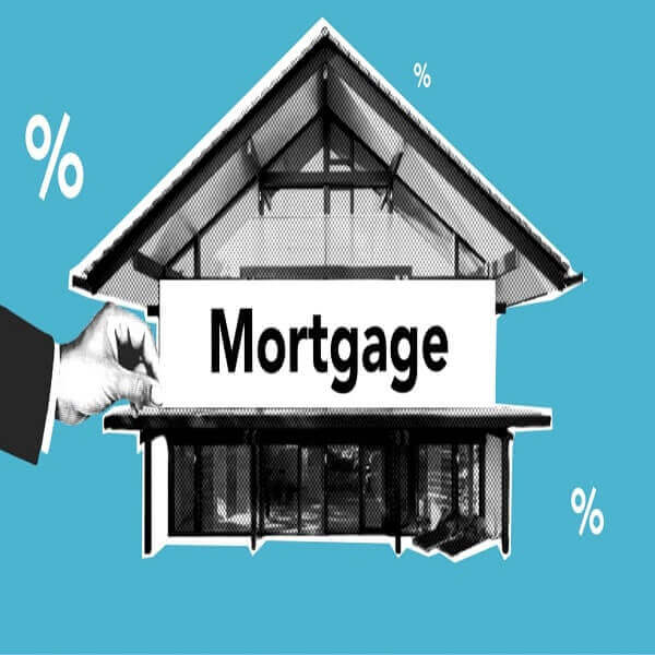 Hand holding mortgage sign with house background