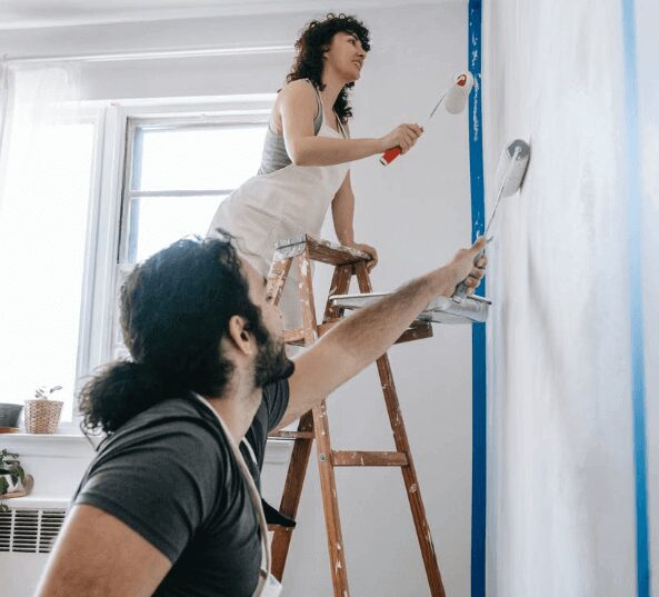 Couple painting a room together