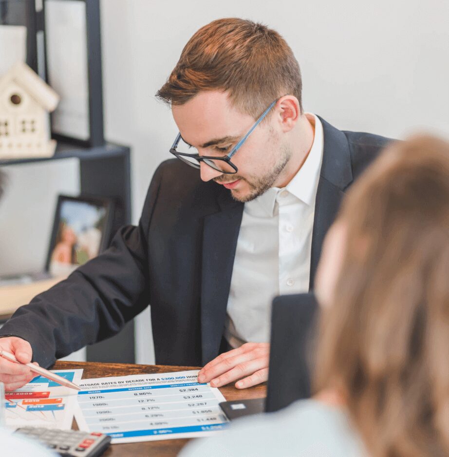 Man reviewing financial documents at a desk.