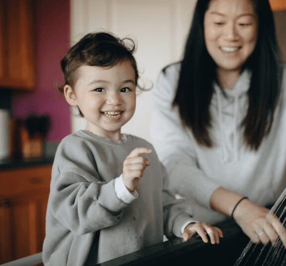 Joyful child and parent cooking together
