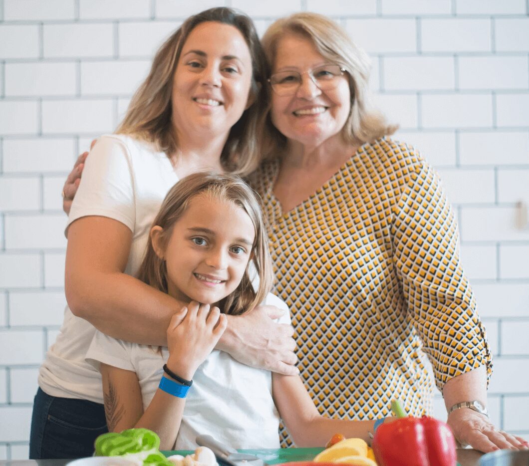 Grandmother, mother, daughter with vegetables