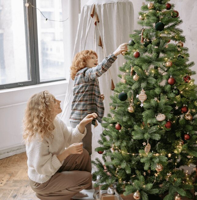 Mother and child decorating tree