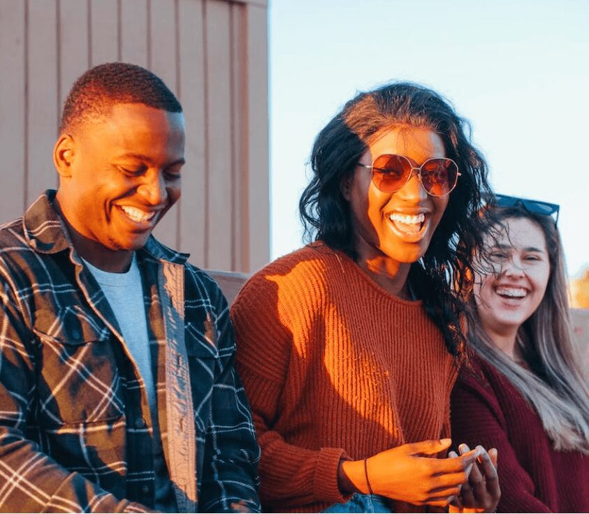 Group of friends laughing outdoors