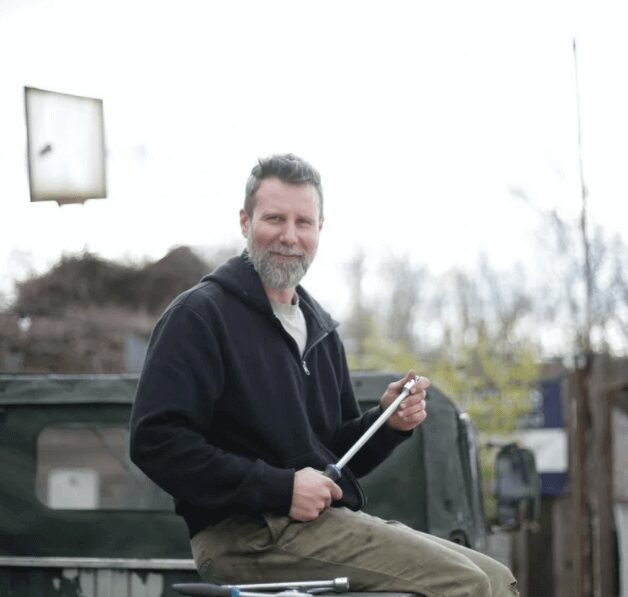 Man holding wrench outdoors