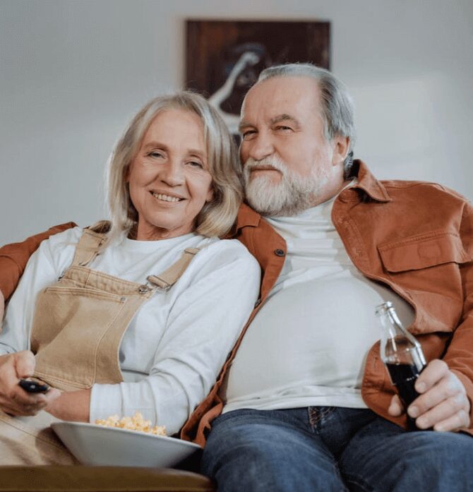 Elderly couple enjoying a movie night