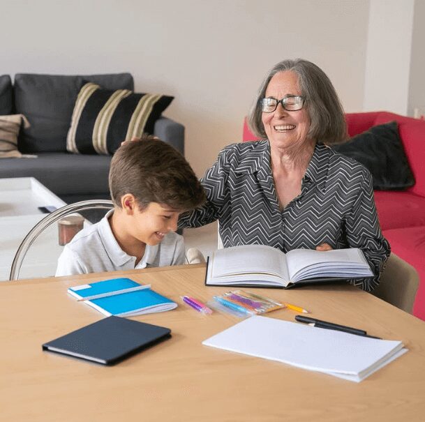 Smiling woman and boy sharing a book