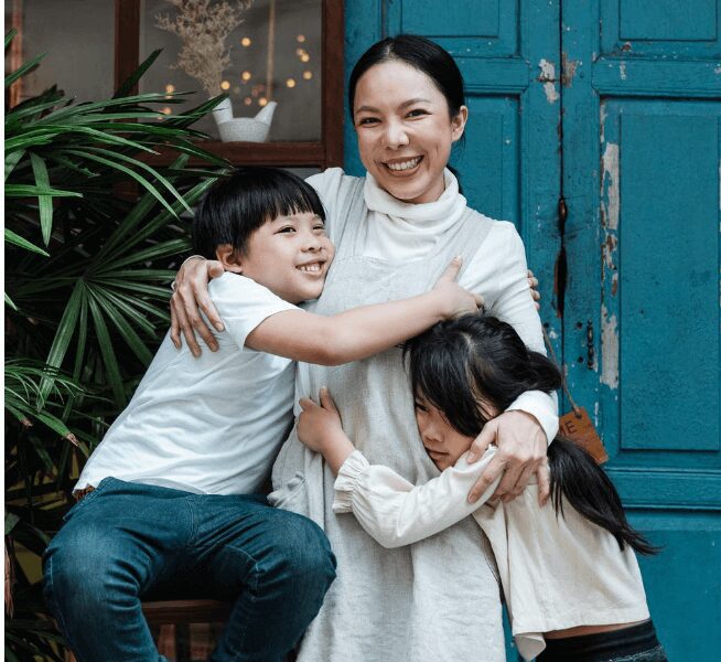 Family embracing in front of blue door