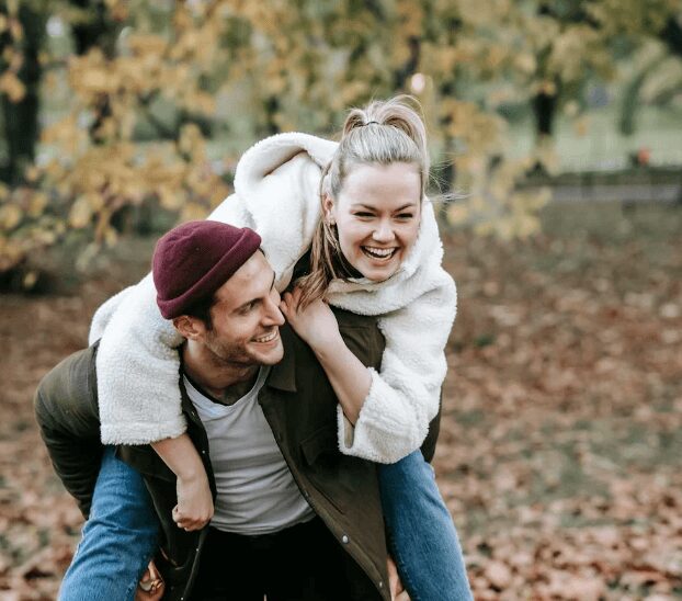 Happy pair enjoying autumn outdoors