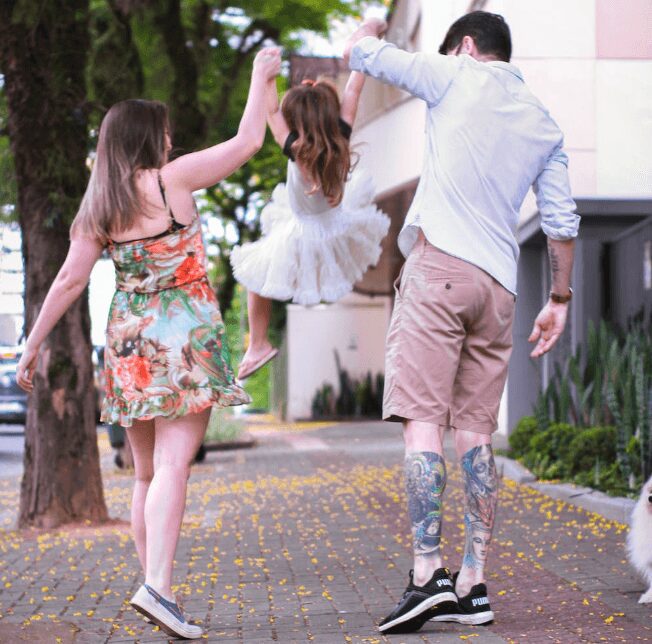 Parents swinging child joyfully