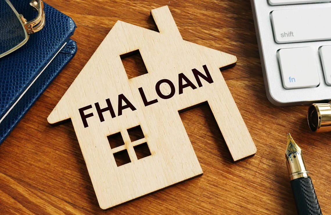 House cutout labeled "FHA Loan" on desk.